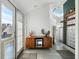 Inviting entryway with a stylish cabinet, mini fridge, modern decor, and natural light from a skylight at 561 Cook St, Denver, CO 80206