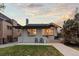 Charming single-story home featuring a well-manicured lawn and inviting front patio at 561 Cook St, Denver, CO 80206