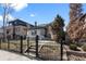 Home exterior featuring manicured lawn, fencing, and brick at 561 Cook St, Denver, CO 80206
