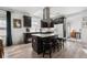 Bright kitchen with a large island, breakfast bar seating, stainless hood, and modern appliances at 561 Cook St, Denver, CO 80206