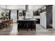 Bright kitchen boasts a large island with seating, stainless steel appliances, and sleek dark cabinets at 561 Cook St, Denver, CO 80206