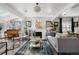 Bright living room has skylights, plants, and a cozy seating area at 561 Cook St, Denver, CO 80206