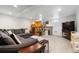 Cozy carpeted living room featuring a large sectional couch and playhouse at 561 Cook St, Denver, CO 80206