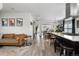 Open concept living space with sleek floors, modern kitchen, cozy seating, and ample natural light at 561 Cook St, Denver, CO 80206