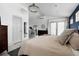 Luxurious main bedroom with a chandelier, private deck access, ensuite bath and chic decor at 561 Cook St, Denver, CO 80206