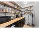 Walk-in pantry with wood countertop, open shelving, storage, and a convenient microwave and toaster at 561 Cook St, Denver, CO 80206