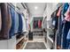 Spacious walk-in closet with custom shelving for organized storage of clothes, shoes, and accessories at 561 Cook St, Denver, CO 80206