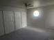 Bright bedroom features natural light, a ceiling fan, and double closets at 12148 Melody Dr # 108, Denver, CO 80234