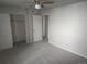 Cozy bedroom with neutral walls, carpet, ceiling fan, closet, and attached bathroom at 12148 Melody Dr # 108, Denver, CO 80234