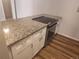 Kitchen counter with white cabinets, stainless steel oven, and granite countertop at 12148 Melody Dr # 108, Denver, CO 80234
