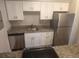 Modern kitchen with granite counters, stainless steel appliances, and white cabinets at 12148 Melody Dr # 108, Denver, CO 80234