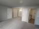 Spacious living room with carpet and view into dining and kitchen areas at 12148 Melody Dr # 108, Denver, CO 80234