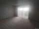 Bright, carpeted living room with access to the exterior at 12148 Melody Dr # 108, Denver, CO 80234