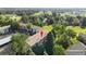 An aerial view of the two-story building surrounded by lush trees and overlooking a golf course at 2150 S Vaughn Way # 302D, Aurora, CO 80014