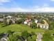 Aerial view of a residential complex with green spaces, mature trees, and a golf course nearby at 2150 S Vaughn Way # 302D, Aurora, CO 80014