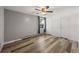 The bedroom features wood floors, a neutral color palette, a ceiling fan, and natural light at 2150 S Vaughn Way # 302D, Aurora, CO 80014