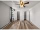 The bedroom features wood floors, a neutral color palette, a ceiling fan, and two closets at 2150 S Vaughn Way # 302D, Aurora, CO 80014
