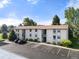 Exterior view of the two-story building with well-maintained landscaping and parking spots at 2150 S Vaughn Way # 302D, Aurora, CO 80014