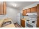 Functional kitchen with light wood cabinets, a white refrigerator and stove, plus ample counter space at 2150 S Vaughn Way # 302D, Aurora, CO 80014