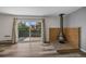 A well-lit living room shows updated floors, an exterior door, and a modern fireplace at 2150 S Vaughn Way # 302D, Aurora, CO 80014