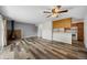 Inviting living room features a decorative fireplace, wood floors, and easy access to the kitchen and outdoor space at 2150 S Vaughn Way # 302D, Aurora, CO 80014