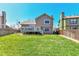 Spacious backyard with green lawn, deck, and privacy fence at 5826 S Jebel Way, Centennial, CO 80015