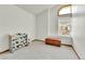 A clean bedroom featuring high ceilings, a window with blinds, and a wooden toy chest at 5826 S Jebel Way, Centennial, CO 80015
