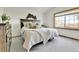 Bright bedroom with a large window, neutral decor, and decorative wall art at 5826 S Jebel Way, Centennial, CO 80015