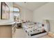 bedroom with a large window, built-in shelving and a neutral color palette at 5826 S Jebel Way, Centennial, CO 80015