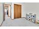 Bedroom featuring neutral carpet, a closet, and white shelving for toy storage at 5826 S Jebel Way, Centennial, CO 80015
