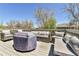 Large deck featuring patio seating and a fire pit with cover at 5826 S Jebel Way, Centennial, CO 80015