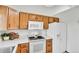 Well-lit kitchen featuring wood cabinets and modern appliances at 5826 S Jebel Way, Centennial, CO 80015