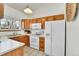 Functional kitchen with white appliances and wooden cabinets at 5826 S Jebel Way, Centennial, CO 80015