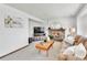Inviting living room featuring a fireplace, television, comfortable sofa, and neutral carpet at 5826 S Jebel Way, Centennial, CO 80015