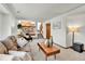 Comfortable living room showcasing neutral carpet, a sofa, a coffee table, and a decorative lamp at 5826 S Jebel Way, Centennial, CO 80015