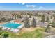 Aerial view of a community pool, parking lot, and residential neighborhood on a clear, sunny day at 5826 S Jebel Way, Centennial, CO 80015