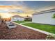 Large backyard with lawn, tidy landscaping, stone path, and detached garage at twilight at 3630 Magnolia St, Denver, CO 80207