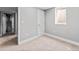 This room has neutral carpet, light-gray walls, and a basement window at 3630 Magnolia St, Denver, CO 80207