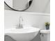This bathroom features a sink with a chrome faucet and white wainscoting at 3630 Magnolia St, Denver, CO 80207