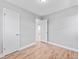 This bedroom features light gray walls and sleek, modern, light-colored, hardwood floors at 3630 Magnolia St, Denver, CO 80207