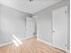 This bedroom features light gray walls and sleek, modern, light-colored, hardwood floors at 3630 Magnolia St, Denver, CO 80207