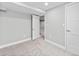 Bright bedroom with neutral carpet, trim, paint, and bright white doors at 3630 Magnolia St, Denver, CO 80207