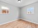 Bright bedroom featuring hardwood floors and natural light from two windows at 3630 Magnolia St, Denver, CO 80207
