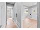 Hallway featuring hardwood floors, with views of the living room, front door, and an adjacent room at 3630 Magnolia St, Denver, CO 80207