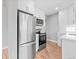 Modern kitchen with stainless steel appliances, white cabinets, and hardwood floors, perfect for cooking at 3630 Magnolia St, Denver, CO 80207