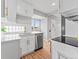 Bright kitchen with stainless steel dishwasher, quartz countertops and breakfast bar at 3630 Magnolia St, Denver, CO 80207