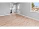 Refinished hardwood floors in an updated, bright living room, seamlessly connecting to the kitchen at 3630 Magnolia St, Denver, CO 80207