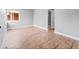 Bright living room with refinished hardwood floors and fresh paint, offering a clean and modern aesthetic at 3630 Magnolia St, Denver, CO 80207