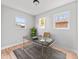 Bright office space with desk, stylish rug, and natural light from two windows at 3630 Magnolia St, Denver, CO 80207