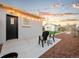 Back patio with string lights, two chairs, and new cement - perfect for evening relaxation and outdoor entertaining at 3630 Magnolia St, Denver, CO 80207